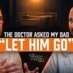 Two men sit facing each other in a dark, warmly lit podcast studio. Large text across the center reads, “THE DOCTOR ASKED MY DAD ‘LET HIM GO’,” with the March or Die logo underneath.