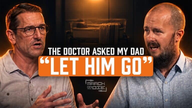Two men sit facing each other in a dark, warmly lit podcast studio. Large text across the center reads, “THE DOCTOR ASKED MY DAD ‘LET HIM GO’,” with the March or Die logo underneath.
